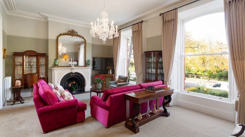 At hall level, the drawing room overlooks the old trees to the front through two tall sash windows at 43 Palmerston Road.
