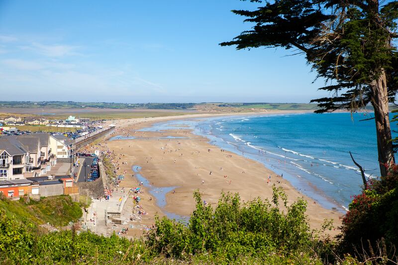 The five kilometre crescent stretch of sand at Tramore, pictured, is one of several blue flag beaches in the county