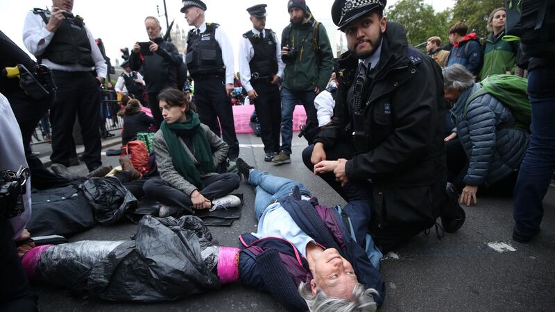Protesters from Extinction Rebellion  block a road in Westminster, London. Photo: Yui Mok/PA
