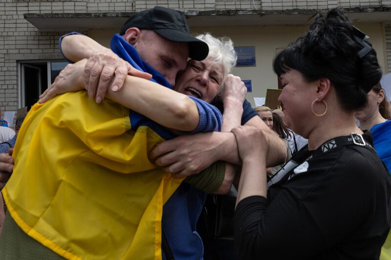Ukrainian families of prisoners of war embrace each other after finally meeting their loved ones on May 25th in Chernihiv, Ukraine. Photograph: Paula Bronstein/Getty Images