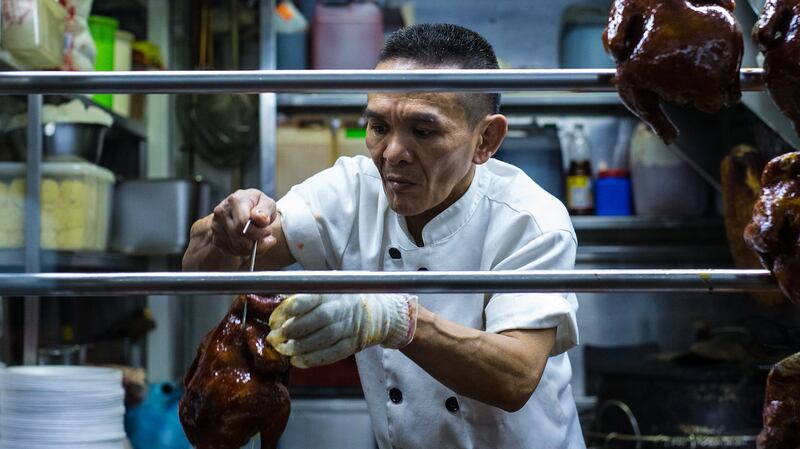 Chan Hong Meng prepares his Hong Kong Chicken Rice and Noodle stall for opening in Singapore