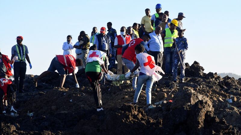 Rescue workers carry wreckage at the crash site of Ethiopia Airlines Boeing 737 Max 8.  All passengers onboard the scheduled flight  died. Photograph: EPA