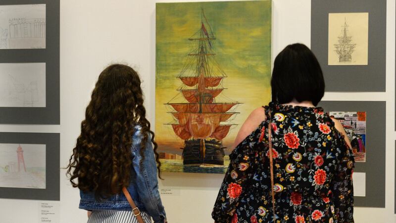 Emma and Anita Curry from East Wall admiring a tall ship painting by Dympna O Halloran. Photograph: Cyril Byrne/The Irish Times