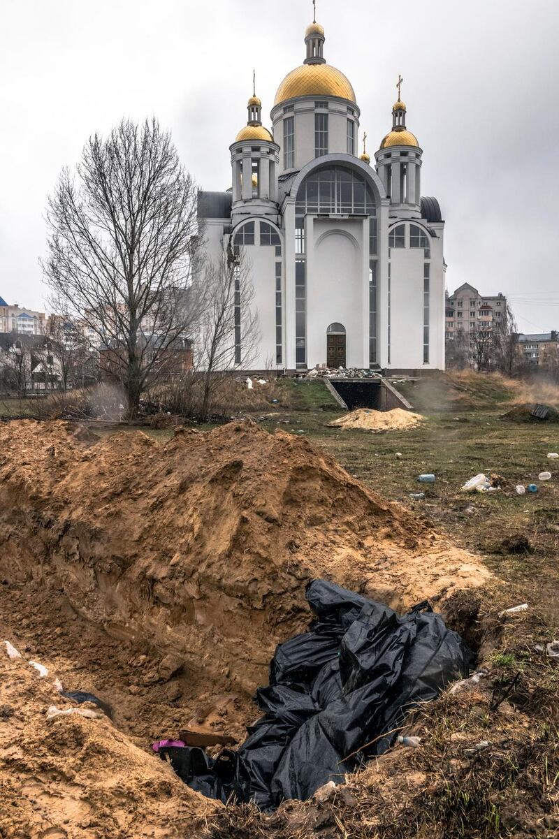 A mass grave was dug near an Orthodox church in Bucha, Ukraine. Photograph: Daniel Berehulak/The New York Times