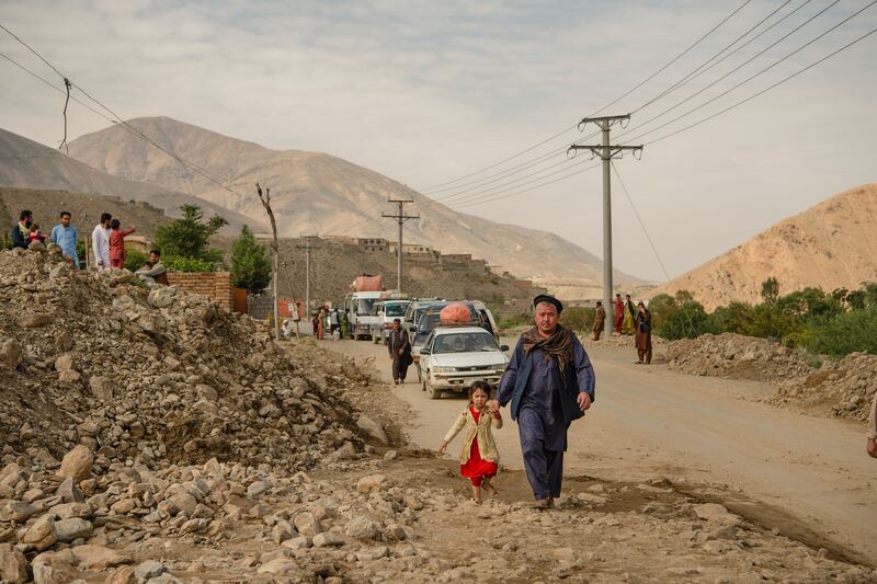 Travellers stranded by road closures caused by the floods wait for the authorities to clear the roads, in Shinwari, eastern Afghanistan, on Wednesday. Photograph: Kiana Hayeri/New York Times