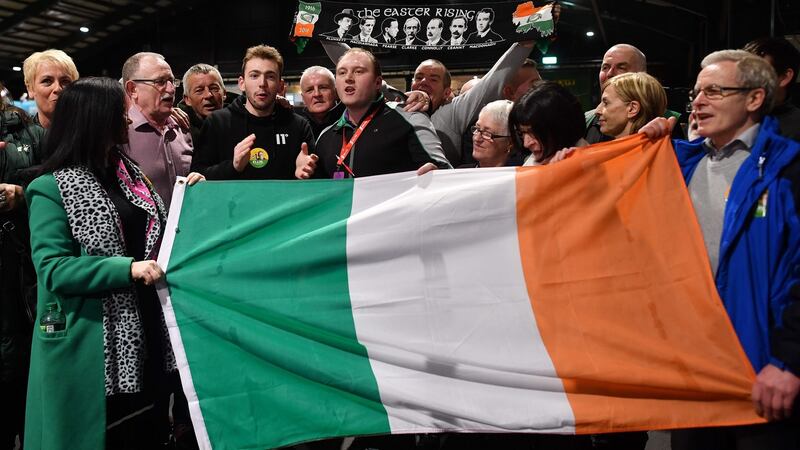 Sinn Féin party supporters sing as they hold a flag during the Dublin City count in the RDS centre in Dublin. Photograph: Ben Stansa/AFP/Getty