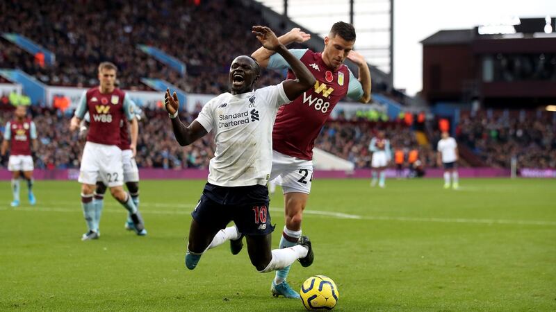 Liverpool’s Sadio Mané goes down in the area under the challenge from Aston Villa’s Frédéric Guilbert and is booked for diving during their late victory at Villa Park. Photograph: Nick Potts/PA Wire