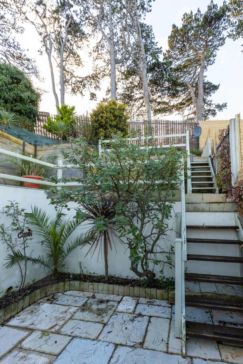 The garden has three tiers, built into the back of a slope.