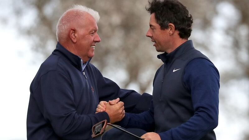 McIlroy with his dad Gerry after his tee shot hit him on the leg. Photo: Jane Barlow/PA Wire