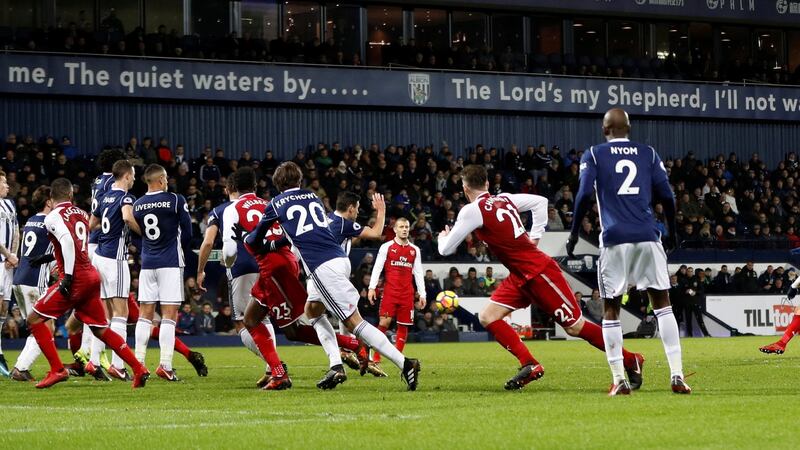 Alexis Sánchez’s late free-kick deflects off James McClean (L) to give Arsenal the lead at the Hawthorns. Photograph: Darren Staples/Reuters