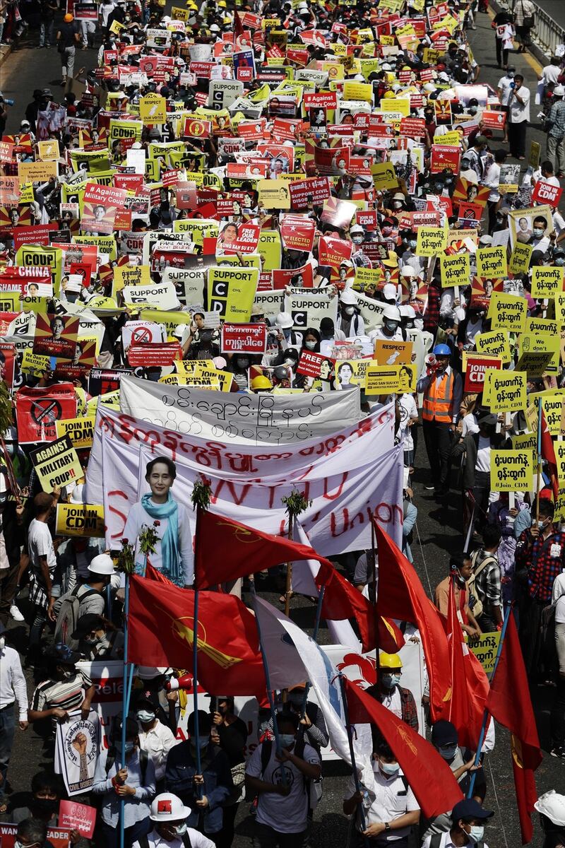 Demonstrators hold placards and banners calling for the release of detained Aung San Suu Kyi, as they block a road on Wednesday. Photograph: Lynn Bo Bo/EPA
