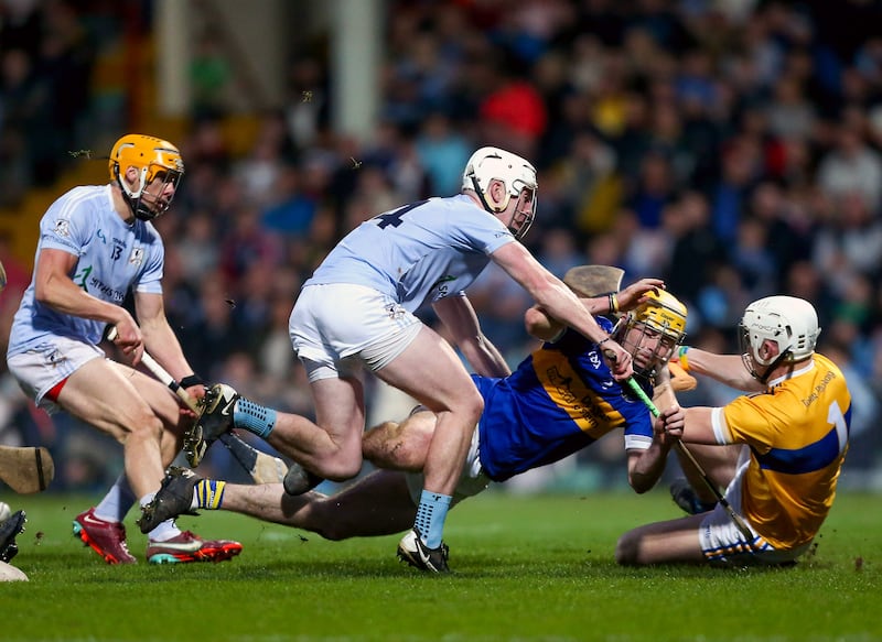 Patrickswell’s Jason Gillane saves at the feet of Na Piarsaigh’s Will Henn. Photograph: Ken Sutton/Inpho 