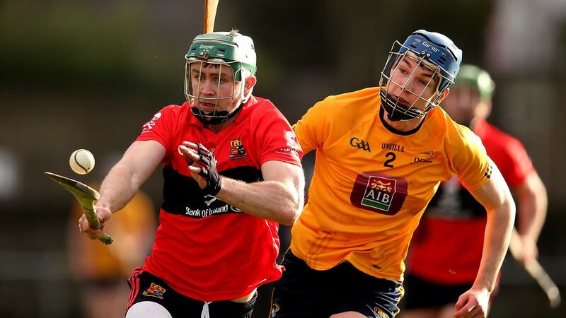 UCC’s Anthony Spillane tries to get away from DCU’s Sean McCaw at the Mardyke Arena. Photograph: Cathal Noonan/Inpho