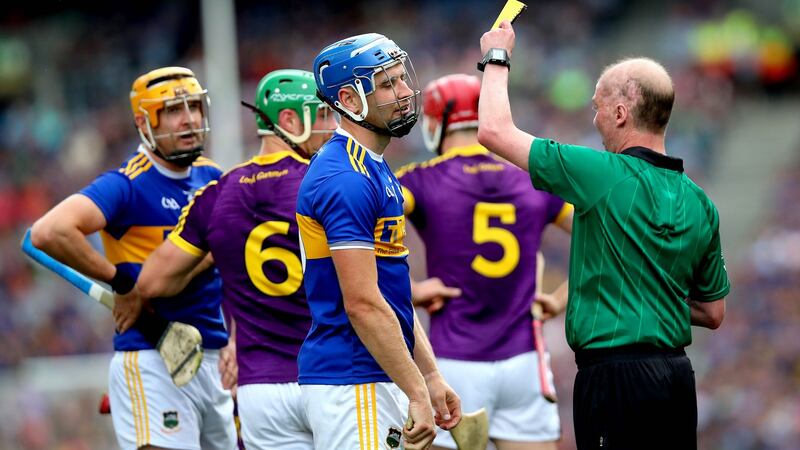 Tipperary’s John McGrath gets a second yellow and is sent off  by referee Seán Cleere in the  All-Ireland hurling semi-final at Croke Park. Photograph: Ryan Byrne/Inpho