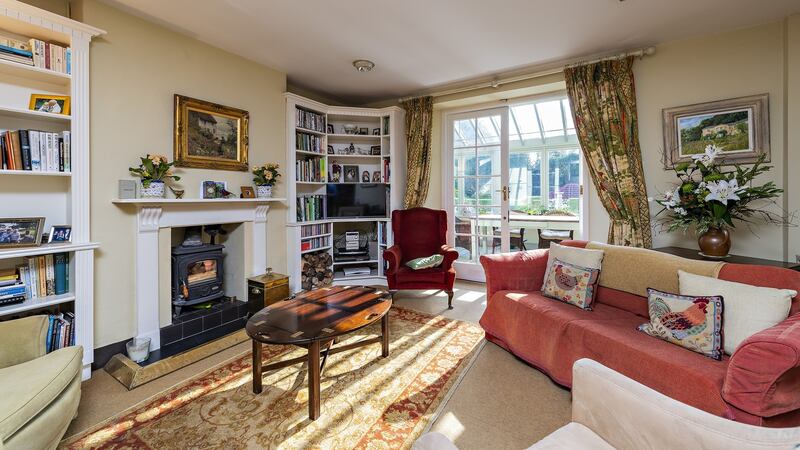 Downstairs the sitting room opens to the conservatory.
