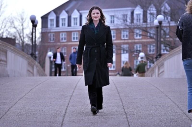 Mortell walking across Harvard bridge
