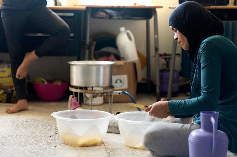 Wafaa Obeid makes yoghurt for her family at the Tyre Technical School, in southern Lebanon. Her family has fled their farm in Ramyah. Photograph: Chris Maddaloni
