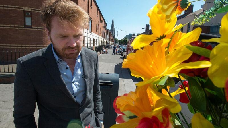 Councillor Gary Gannon examines a floral tribute on Sherriff Street to the man who was shot dead in a case of mistaken identity recently. Photograph: Dave Meehan/The Irish Times