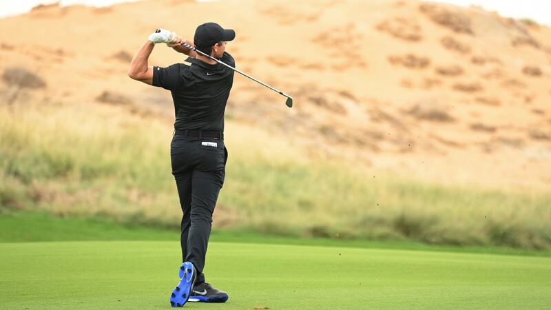 Rory McIlroy hits his second shot on the seventh hole during the first round of the Abu Dhabi HSBC Championship at Yas Links Golf Course. Photograph: Ross Kinnaird/Getty Images