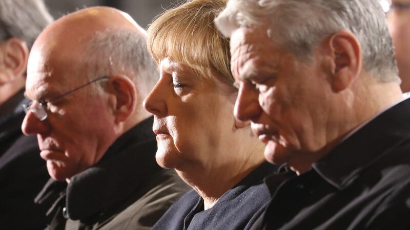Germany’s president Joachim Gauck, chancellor Angela Merkel and parliament president Norbert Lammert attend a memorial service in Berlin’s Kaiser-Wilhelm memorial church for the victims of the truck attack. Photograph: Michael Kappeler/AP