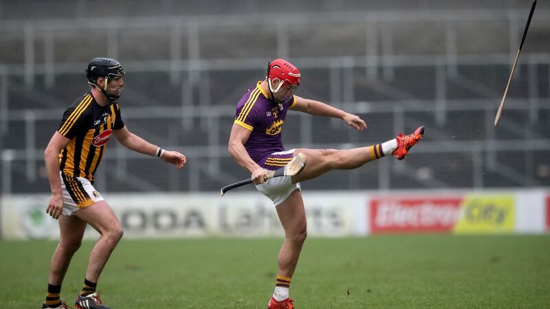 Lee Chin kicks Kilkenny’s Conor O’Shea’s hurl out of play. Photo: Ryan Byrne/Inpho