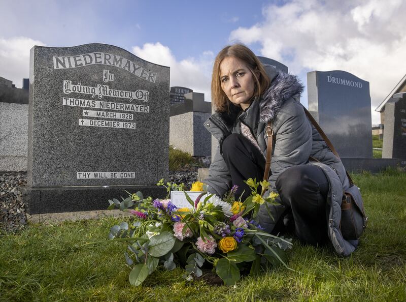 Tanya Williams-Powell, the granddaughter of Thomas Niedermayer killed by the IRA in 1973, visits his grave on the outskirts of Belfast at Derriaghy Parish Church of Ireland. Photograph: Liam McBurney/PA