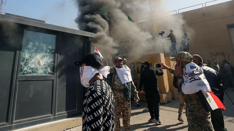 Protesters set ablaze a sentry box in front of the US embassy building in the  Baghdad on Tuesday. Photograph: Getty