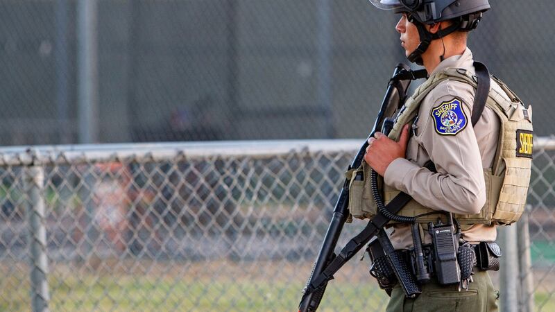 A police officer stands watch at the scene of a mass shooting during the Gilroy Garlic Festival in Gilroy, California. Photograph: Reuters