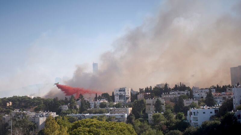 An Israeli firefighter plane helps extinguish a fire that erupted in a suburb of the coastal city of Haifa, northern Israel. Photograph: Moran Mayan/EPA