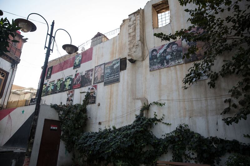 Across government-held Syria, walls are covered in pictures of local "martyrs", people who have died fighting for the government during the war. This wall is in Bab Touma in Damascus. Photograph: Sally Hayden