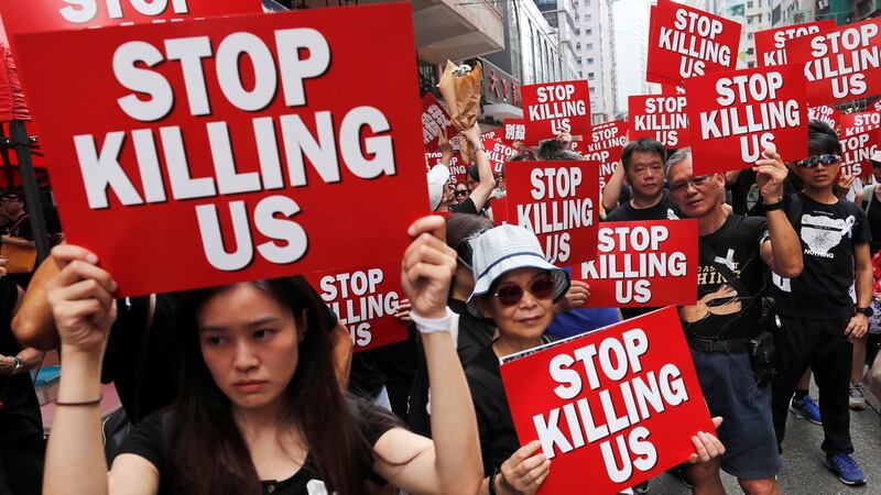 Protesters hold placards as they attend a demonstration demanding Hong Kong’s leaders to step down and withdraw the extradition bill, in Hong Kong, China, June 16, 2019. Photograph: REUTERS/Tyrone Siu