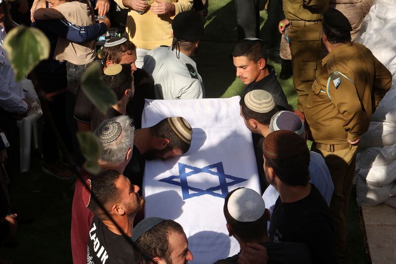 Mourners take part in the funeral of Israeli settlers, brothers Yagel Yaniv, (20), and Hallel Yaniv (22), at the military cemetery in Jerusalem on February 27th, a day after they were shot dead as they drove through Huwara town in the occupied West Bank. Photograph: Gil Cohen-Magen/AFP via Getty Images.  