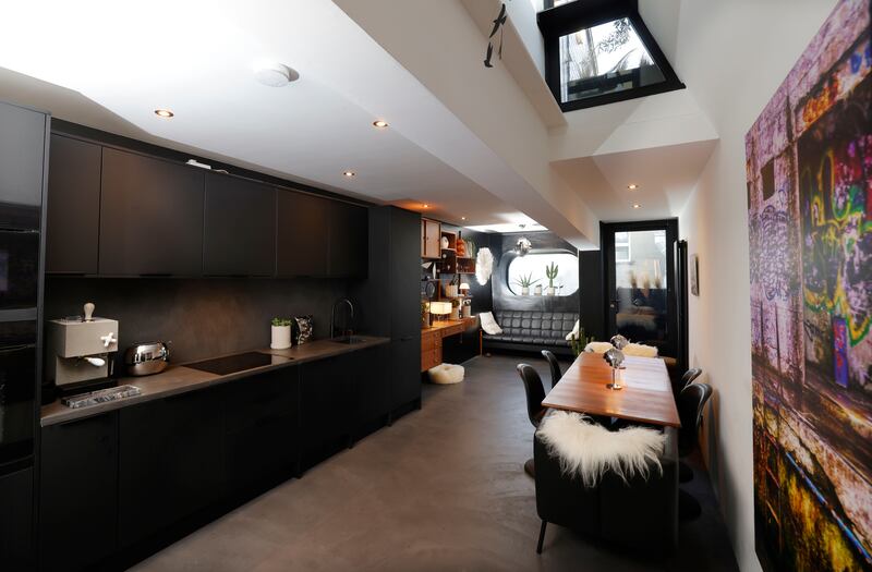 Verner Panton chairs surround the teak dining table. Some sport Icelandic long-haired sheepskins from Nordic Elements. A cowskin rug was found in TK Maxx. The kitchen was made by Howdens. The sheepskin bed for Gráinne Wynne's deerhead chihuahua, Neuvo, is from Stable

