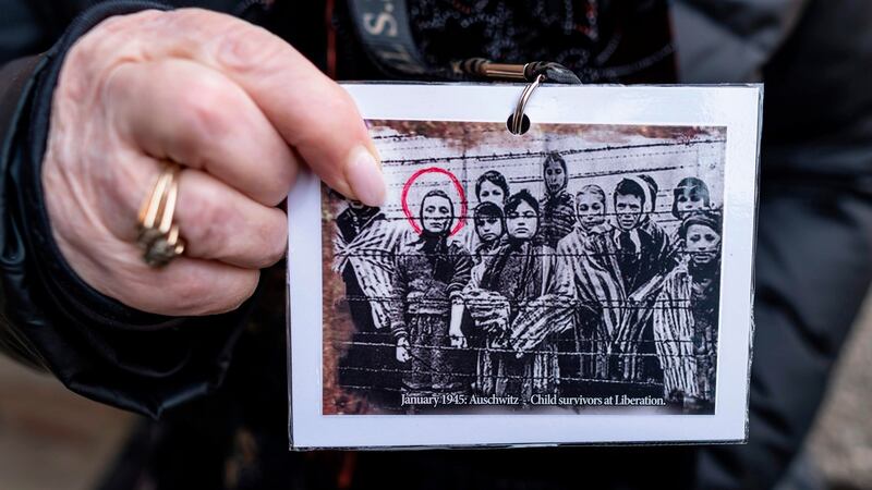 Holocaust survivor and former prisoner of  Nazi death camp Auschwitz-Birkenau, Miriam Ziegler, shows a picture of her  and other prisoners taken in January 1945, at the camp museum  on Sunday, one day before the 75th anniversary of its liberation. Photograph: Wojtek Radwanski/AFP/Getty