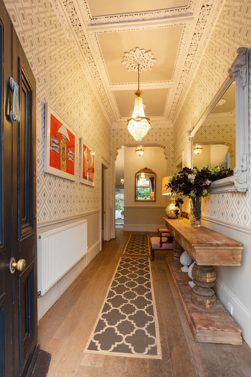 3 Marlborough Road: The entrance hall has wide-plank solid-wood floors, a dado rail, ceiling coving and centre roses, and a squared archway leading to the less-formal end of the house.