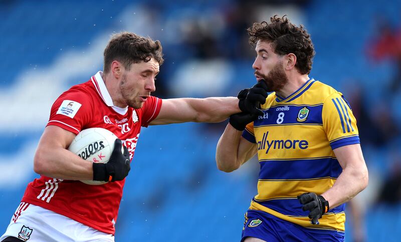 Roscommon's Eddie Nolan tackles Paul Walsh of Cork. Photograph: Leah Scholes/Inpho
