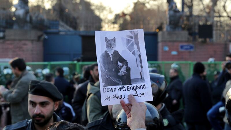 A pro-government protester holds up a placard during a demonstration in front of the British Embassy in Tehran on Sunday. Photograph /Ebrahim Noroozi