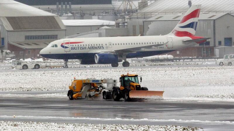 A snow plough clears the runway at Belfast City airport today. Photograph: Cathal McNaughton/Reuters