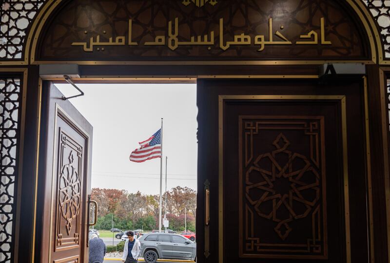 A US flag outside the Islamic Center of America in Dearborn, Michigan.  Dearborn, a suburb of roughly 110,000 people bordering Detroit, has one of the highest percentages of Arab Americans among US cities. Photograph: Valaurian Waller/The New York Times
                      