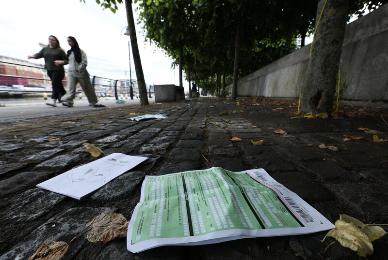 Discarded Irish passport application forms and tent instructions pictured  on City Quay, Dublin where an asylum-seeker camp was allegedly attacked. Photograph: Colin Keegan/Collins Dublin