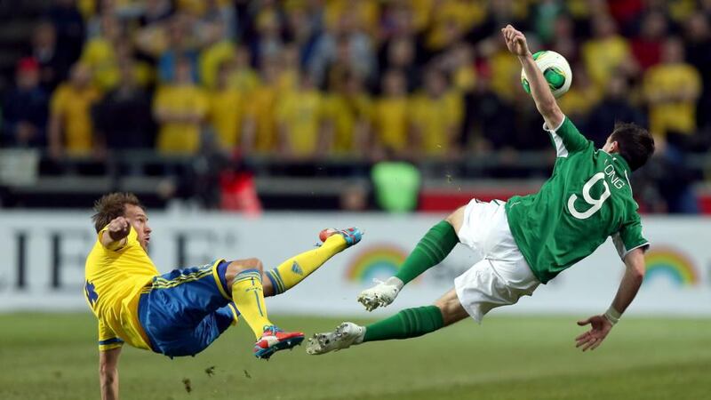 Sweden's Andreas Granqvist and Shane Long of Ireland go for the ball