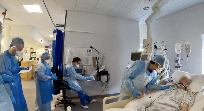 11.50am: Medical staff work on a Covid-19 patient in ICU. Photograph: Alan Betson