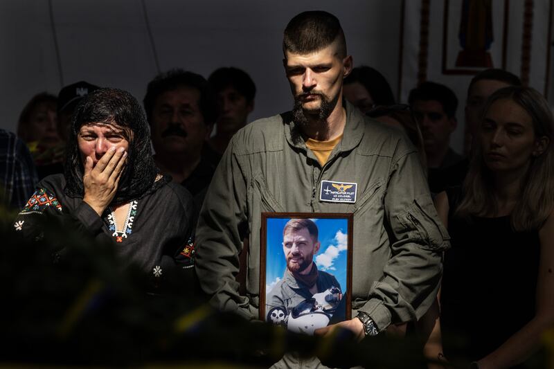 Lilia Averianova, mother of fighter pilot Andrii 'Juice' Pilshchykov, and Ukrainian pilot Lieut Col Oleg Klymov at Pilshchykov's funeral in Kyiv on Tuesday. Photograph: Paula Bronstein/ Getty Images