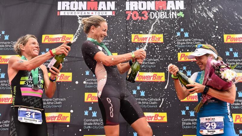 All about the joy:  Susie Cheetham (centre) of Great Britain, celebrates her Dublin IronMan 70.3 win with, in  second place, Samantha Warriner (left) of New Zealand, and, in  third, Sonja Tajisich, of Germany.  Photograph: David Maher/Sportsfile