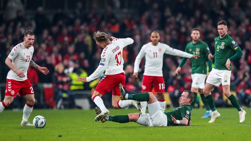 Ireland’s Glenn Whelan tackles Jens Stryger Larsen.