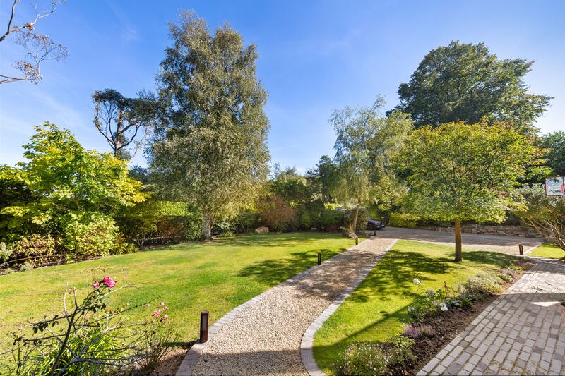 The garden lawns stretch from front to rear