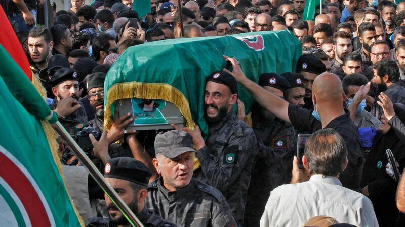 Members of the Amal movement carry the flag-draped casket of a fellow fighter who was killed in clashes in Beirut. Photograph: Mahmoud Zayyat/AFP via Getty