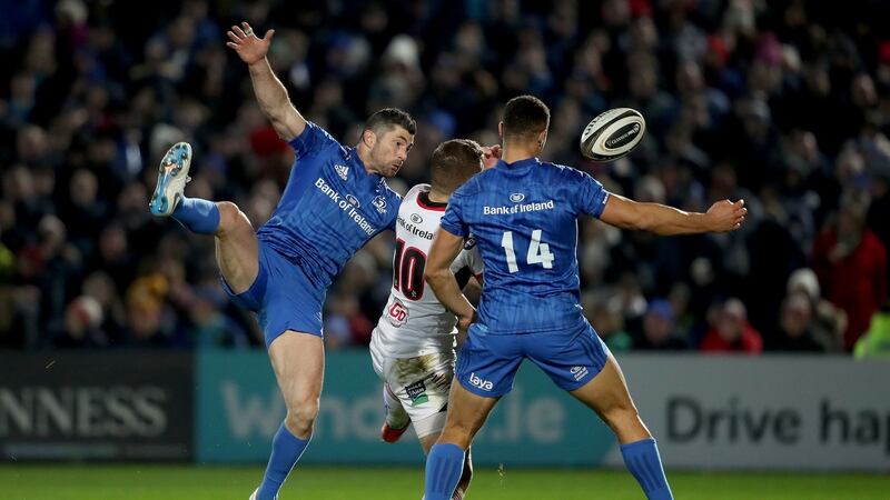 Rob Kearney challenges Ulster’s Johnny McPhillips as Adam Byrne looks on. Photograph: Dan Sheridan/Inpho