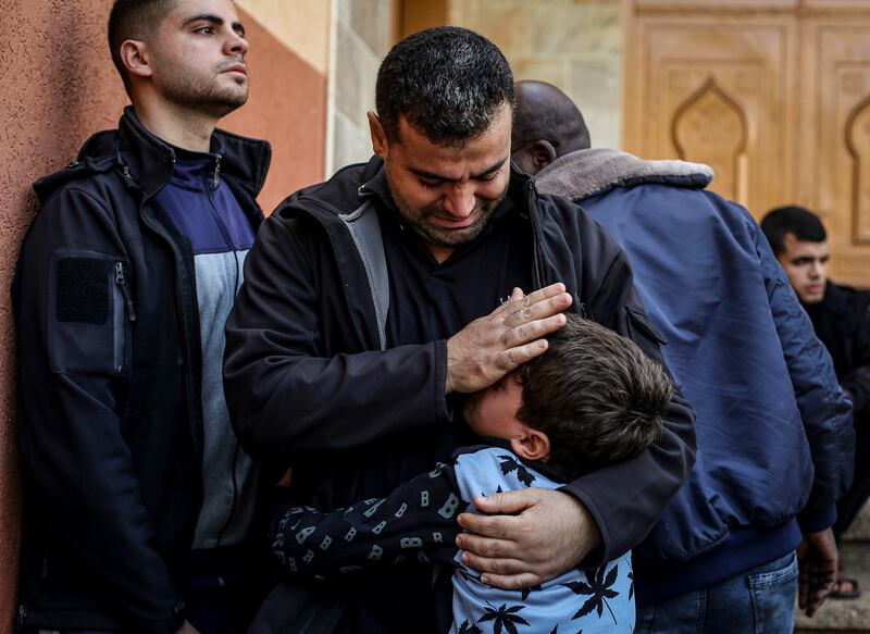 Palestinians mourning relatives killed by Israeli air strikes in Khan Younis. Photograph: Yousef Masoud/The New York Times
                      