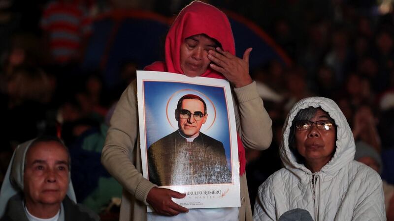 A woman cries as she listens to Pope Francis’s canonisation of Pope Paul VI and Salvadoran Archbishop Oscar Romero in San Salvador, El Salvador on Sunday morning. Photograph: EPA
